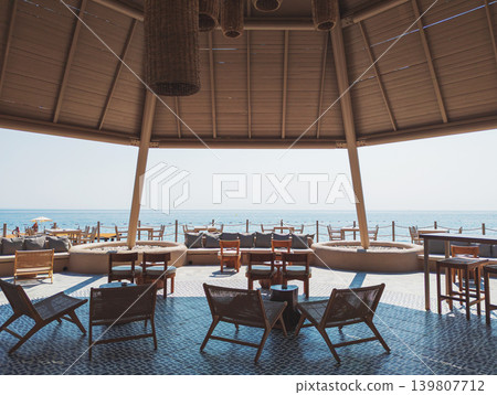 Beach bar pavilion in a Kemer resort offering seaside relaxation Beach bar pavilion in a Kemer resort offering seaside relaxation 139807712