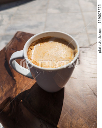 Coffee latte on wood table at resort terrace Coffee latte on wood table at resort terrace 139807713