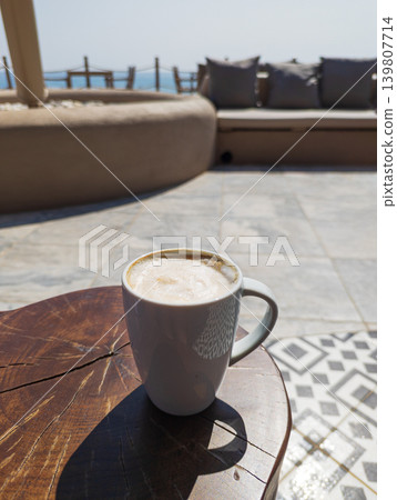 Coffee latte on wood table at resort terrace Coffee latte on wood table at resort terrace 139807714