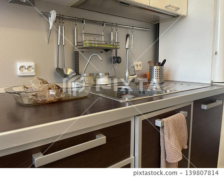 a sink in the kitchen with lamp lighting a sink in the kitchen with lamp lighting 139807814