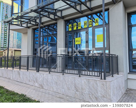 Vacant commercial property for rent with Russian sign on modern building facade Vacant commercial property for rent with Russian sign on modern building facade 139807824