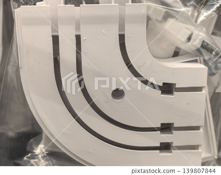 White plastic curved curtain track rail components in packaging White plastic curved curtain track rail components in packaging 139807844