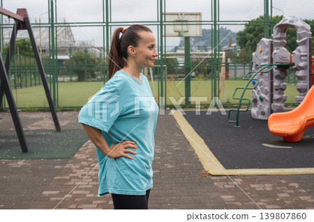 Attractive healthy woman 40s before training outdoors portrait Attractive healthy woman 40s before training outdoors portrait 139807860