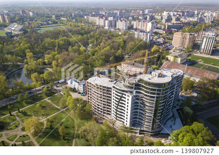 Apartment or office tall building under construction, top view. Drone aerial photography. Apartment or office tall building under construction, top view. Drone aerial photography. 139807927