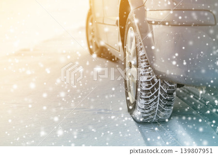 Close-up of car wheels rubber tires in deep winter snow. Transportation and safety concept. Close-up of car wheels rubber tires in deep winter snow. Transportation and safety concept. 139807951