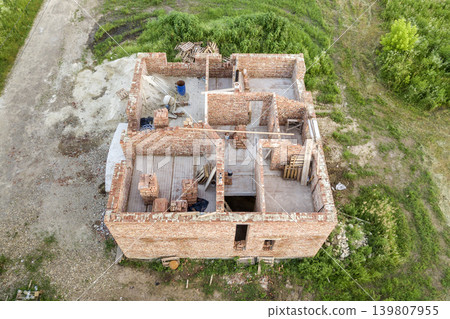 Aerial view of building site for future house, brick basement floor and stacks of brick for construction. Aerial view of building site for future house, brick basement floor and stacks of brick for construction. 139807955