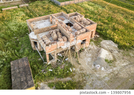 Aerial view of building site for future house, brick basement floor and stacks of brick for construction. Aerial view of building site for future house, brick basement floor and stacks of brick for construction. 139807956