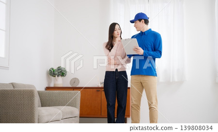 A woman moving and a moving company A woman moving and a moving company 139808034