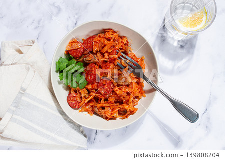 Bigos, Polish dish bigos, on a marble table, stewed meat with cabbage, chorizo sausages, mushrooms, homemade, without people, Bigos, Polish dish bigos, on a marble table, stewed meat with cabbage, chorizo sausages, mushrooms, homemade, without people, 139808204