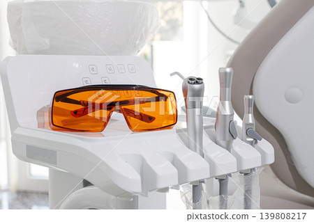 Dental instruments and safety glasses on the module, there are no people in the dental clinic Dental instruments and safety glasses on the module, there are no people in the dental clinic 139808217