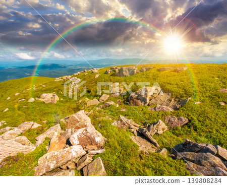 sunset over alpine grassy meadow. carpathian mountains landscape with huge boulders. alpine nature scenery of ukraine highlands in summer. view of remote place in mountains under the rainbow sunset over alpine grassy meadow. carpathian mountains landscape with huge boulders. alpine nature scenery of ukraine highlands in summer. view of remote place in mountains under the rainbow 139808284