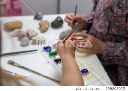 Children Painting Stones With Colorful Paints During Creative Craft Activity. Children Painting Stones With Colorful Paints During Creative Craft Activity. 139808925