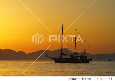 Wooden Gulet returning to the harbor at sunset. Wooden Gulet returning to the harbor at sunset. 139808961