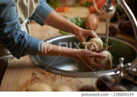 Hands, sink and water, clean vegetables and cooking food with hygiene and health at home. Turnip, organic for lunch or dinner, washing ingredient and meal prep with chef skill and cuisine in kitchen Hands, sink and water, clean vegetables and cooking food with hygiene and health at home. Turnip, organic for lunch or dinner, washing ingredient and meal prep with chef skill and cuisine in kitchen 139809154