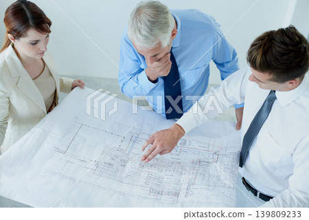Blueprint, architecture or top view of team planning project, maintenance or renovation in meeting. Civil engineering, people building or group of designers with floor plan for property development Blueprint, architecture or top view of team planning project, maintenance or renovation in meeting. Civil engineering, people building or group of designers with floor plan for property development 139809233
