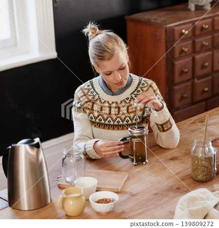 Woman, happy and herbal tea for wellness in home and warm beverage of herbs mixture for health. Kitchen, lady and detox with dry leaves in plunger and chamomile drink to relax in apartment in above Woman, happy and herbal tea for wellness in home and warm beverage of herbs mixture for health. Kitchen, lady and detox with dry leaves in plunger and chamomile drink to relax in apartment in above 139809272