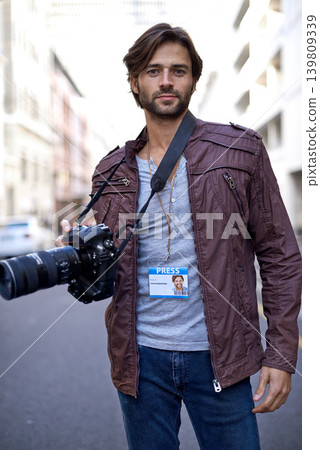 Press, photographer and portrait with camera outdoor in city for photoshoot with gear to film on street. Travel, photography and creative cameraman shooting with lens to capture urban media on road Press, photographer and portrait with camera outdoor in city for photoshoot with gear to film on street. Travel, photography and creative cameraman shooting with lens to capture urban media on road 139809339