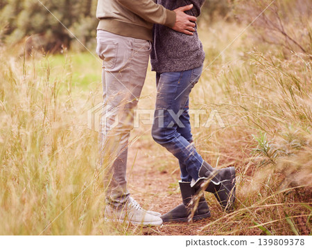 Nature, legs and hug with couple in countryside together for romance, bonding or dating on field of grass. Love, earth or environment with man and woman embracing outdoor for anniversary closeup Nature, legs and hug with couple in countryside together for romance, bonding or dating on field of grass. Love, earth or environment with man and woman embracing outdoor for anniversary closeup 139809378