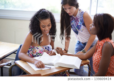 Women, students and textbook reading in university for group assignment for project, education or learning. Female people, friends and notes in college classroom for academic research, exam or course 139809414