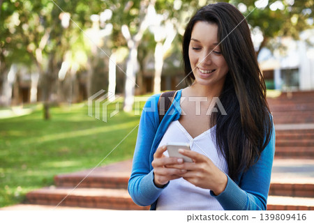 College, woman and typing outdoor with phone for social media and walking with communication on campus. Online, chat and girl with virtual contact on smartphone, connection and networking in Paris 139809416