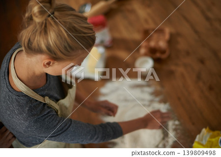 Woman, baking and relax in a kitchen with flour and dough for bread in a home. Food, above and cooking a dessert in a house with wheat powder, nutrition and lunch recipe on a table with a baker 139809498