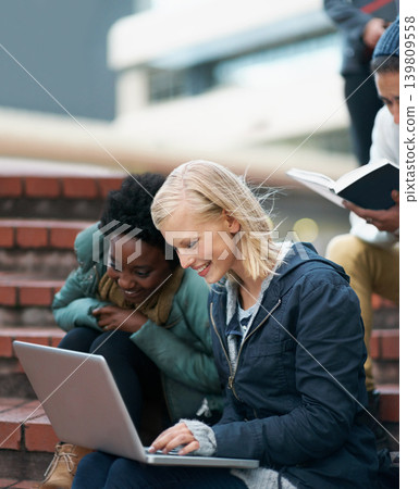 College, women and laptop on stairs outdoor for research, relax or break on campus with social media. University, students and smile with technology for internet, streaming or learning and diversity College, women and laptop on stairs outdoor for research, relax or break on campus with social media. University, students and smile with technology for internet, streaming or learning and diversity 139809558