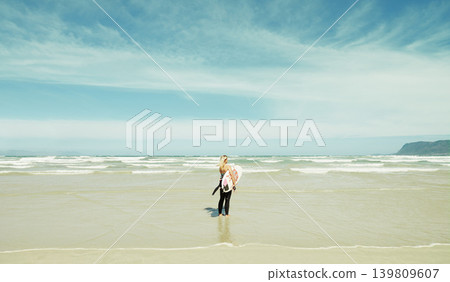Beach, sky or space and woman with surfboard outdoor in summer for travel, sports or seascape view. Water, training and sand with surfer person by sea or ocean for fitness or exercise from back Beach, sky or space and woman with surfboard outdoor in summer for travel, sports or seascape view. Water, training and sand with surfer person by sea or ocean for fitness or exercise from back 139809607