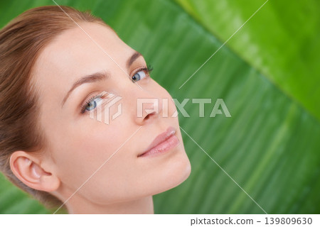 Woman, skincare and portrait with leaves, health and sustainability for organic cosmetics. Girl, person or model with palm tree for wellness, touch or glow with dermatology for facial skin by plants Woman, skincare and portrait with leaves, health and sustainability for organic cosmetics. Girl, person or model with palm tree for wellness, touch or glow with dermatology for facial skin by plants 139809630