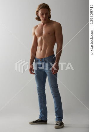 Shirtless, model and man in jeans on studio, white background and mockup with fashion. Male, beauty and handsome topless person with abs in denim pants, cool style and confidence in backdrop Shirtless, model and man in jeans on studio, white background and mockup with fashion. Male, beauty and handsome topless person with abs in denim pants, cool style and confidence in backdrop 139809713