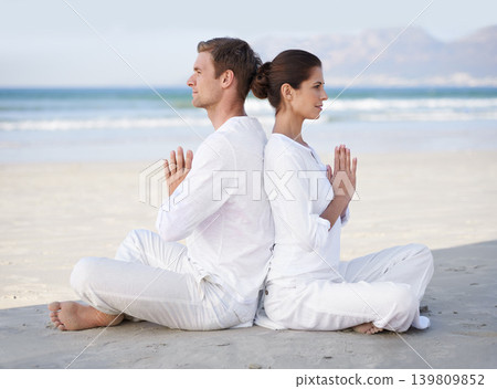 Couple, yoga and beach with meditation, sitting and peace on sand in morning with mindfulness in summer. Man, woman and outdoor for namaste with spiritual growth, balance or zen by ocean in Cape Town 139809852