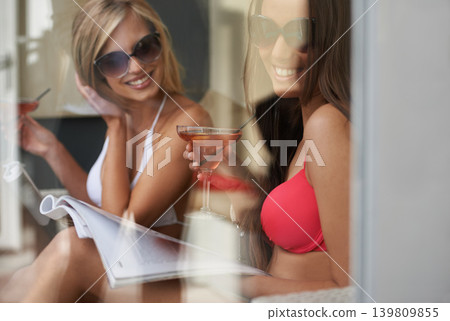 Friends, relax and women with cocktails, smile and happiness with vacation and weekend break. People, girls and alcohol drinks on a holiday and bonding together with getaway trip or magazine with joy Friends, relax and women with cocktails, smile and happiness with vacation and weekend break. People, girls and alcohol drinks on a holiday and bonding together with getaway trip or magazine with joy 139809855