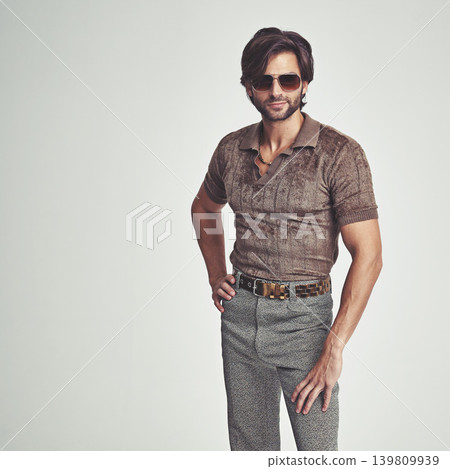 Man, portrait and retro fashion in studio for vintage look, sunglasses and unique trendy clothes for old school feel. Confident, person and comic display for different style, weird and mockup space Man, portrait and retro fashion in studio for vintage look, sunglasses and unique trendy clothes for old school feel. Confident, person and comic display for different style, weird and mockup space 139809939