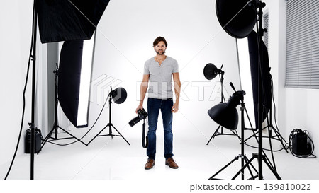Photographer, portrait or lighting with equipment in studio for career, behind the scenes or camera. Photography, guy and confidence with electronics, flash or shooting gear for photoshoot or passion Photographer, portrait or lighting with equipment in studio for career, behind the scenes or camera. Photography, guy and confidence with electronics, flash or shooting gear for photoshoot or passion 139810022