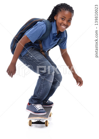 Skateboard, student or portrait of African kid in studio with smile, skill or trick with bag or cool style. Skater, performance or happy child skateboarding with energy isolated on white background Skateboard, student or portrait of African kid in studio with smile, skill or trick with bag or cool style. Skater, performance or happy child skateboarding with energy isolated on white background 139810023
