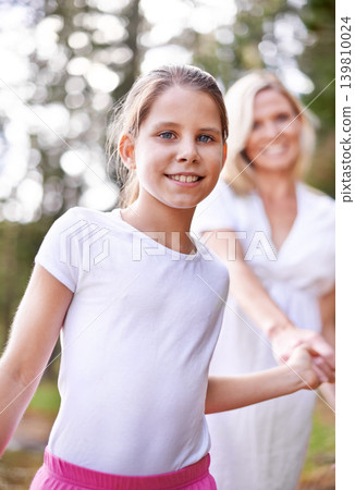 Girl, child and portrait outdoor with happiness for bonding, support or holding hands with mother on holiday in nature. Family, woman or daughter with face, smile or trust on vacation, travel or love Girl, child and portrait outdoor with happiness for bonding, support or holding hands with mother on holiday in nature. Family, woman or daughter with face, smile or trust on vacation, travel or love 139810024