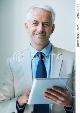 Portrait, man and CEO with tablet in corporate for networking, communication or task management with confident smile. Male person, boss and technology for planning, agenda or research in office Portrait, man and CEO with tablet in corporate for networking, communication or task management with confident smile. Male person, boss and technology for planning, agenda or research in office 139810045
