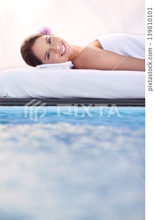 Massage, portrait and woman at spa poolside for health, wellness and luxury holistic treatment. Self care, peace and face of girl on pool bed for body therapy, comfort and calm hotel service to relax Massage, portrait and woman at spa poolside for health, wellness and luxury holistic treatment. Self care, peace and face of girl on pool bed for body therapy, comfort and calm hotel service to relax 139810101