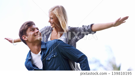 Couple, piggy back and plane with arms, smile or game by trees with care for connection with bonding outdoor. Man, woman and playful with airplane, wings or flight for freedom on journey for vacation Couple, piggy back and plane with arms, smile or game by trees with care for connection with bonding outdoor. Man, woman and playful with airplane, wings or flight for freedom on journey for vacation 139810195