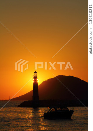 Seascape at sunshine. Lighthouse and sailings on the coast. Seaside town of Turgutreis and spectacular sunshine 139810211