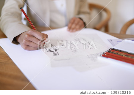 Tailor, hands or drawing on paper with pencil in startup office of small business. Creative, closeup or fashion designer sketch at desk for project illustration, planning or writing draft for clothes Tailor, hands or drawing on paper with pencil in startup office of small business. Creative, closeup or fashion designer sketch at desk for project illustration, planning or writing draft for clothes 139810216