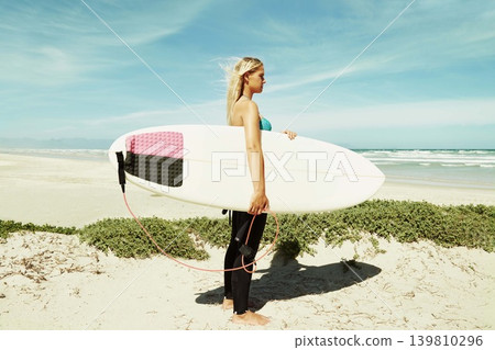 Beach, sports and woman in wind with surfboard on vacation or holiday for training, fitness and exercise. Profile, nature and sand with confident young surfer person in tropical location for travel Beach, sports and woman in wind with surfboard on vacation or holiday for training, fitness and exercise. Profile, nature and sand with confident young surfer person in tropical location for travel 139810296