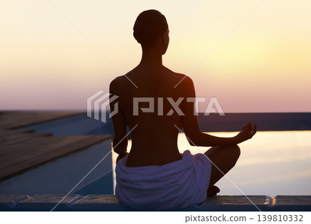 Back, yoga and woman meditate at sunset by swimming pool for healthy body, wellness and zen outdoor on mockup space. Rear view, lotus pose and silhouette of person at twilight to relax, peace or calm 139810332