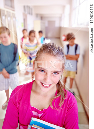 Child, friends and portrait in school hallway or classroom learning or students unhappy for lesson, knowledge or elementary. Girl, face and books or smile for education future in USA, campus or smart 139810358