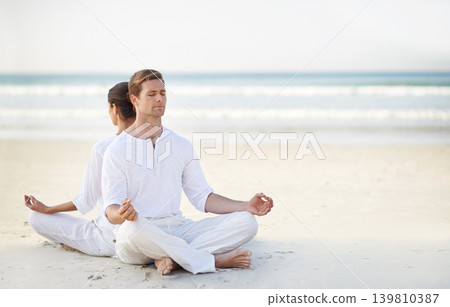 Couple, yoga and sea with meditation, sand or waves with sitting in morning for mindfulness with space. Man, woman and peace for namaste with spiritual growth, balance and zen at beach in Cape Town Couple, yoga and sea with meditation, sand or waves with sitting in morning for mindfulness with space. Man, woman and peace for namaste with spiritual growth, balance and zen at beach in Cape Town 139810387
