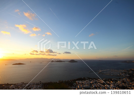 Seaside town of Turgutreis and spectacular sunsets. aerial view of islands and sea Seaside town of Turgutreis and spectacular sunsets. aerial view of islands and sea 139810651
