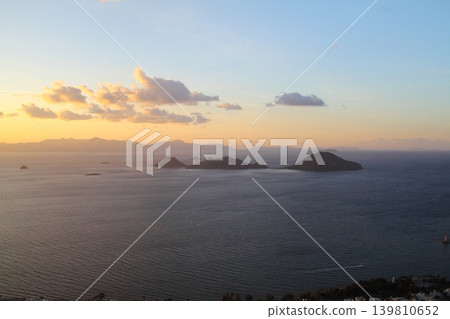 Seaside town of Turgutreis and spectacular sunsets. aerial view of islands and sea Seaside town of Turgutreis and spectacular sunsets. aerial view of islands and sea 139810652