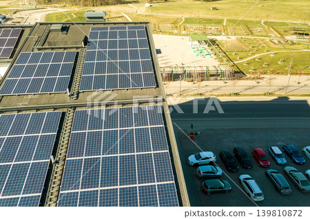 Aerial view of solar photovoltaic panels on a roof top of residential building block for producing clean electric energy. Autonomous housing concept. 139810872