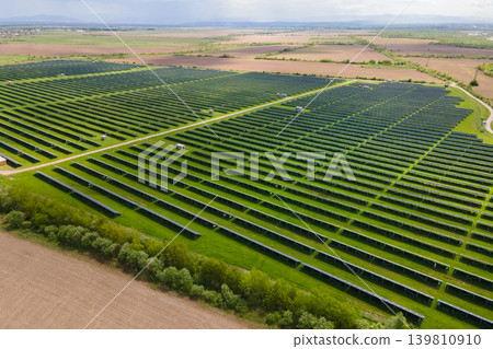 Aerial view of big sustainable electric power plant with many rows of solar photovoltaic panels for producing clean ecological electrical energy. Renewable electricity with zero emission concept. 139810910