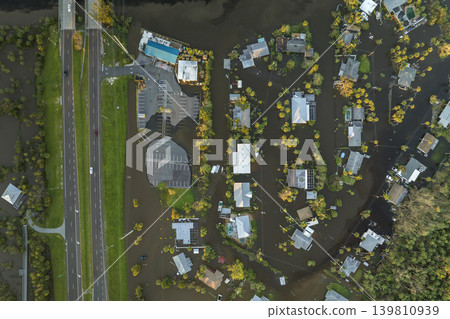 Heavy flood with high water surrounding residential houses after hurricane Ian rainfall in Florida residential area. Consequences of natural disaster Heavy flood with high water surrounding residential houses after hurricane Ian rainfall in Florida residential area. Consequences of natural disaster 139810939