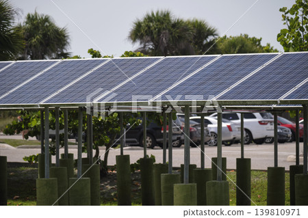 Solar panels installed on stand frame near parking lot for effective generation of clean electricity. Photovoltaic technology integrated in urban infrastructure for electric car charging Solar panels installed on stand frame near parking lot for effective generation of clean electricity. Photovoltaic technology integrated in urban infrastructure for electric car charging 139810971